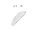 Áferð á hárnæringu sem sýnir kremkennda formúlu sem nærir og mýkir hár